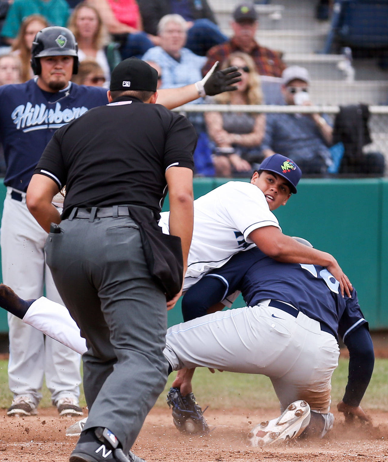 Everett’s Andres Torres looks for the call as he tags out Hillsboro’s Eudy Ramos Sunday afternoon at Everett Memorial Stadium in Everett on June 18, 2017. Aquasox won 6-3. (Kevin Clark / The Herald)