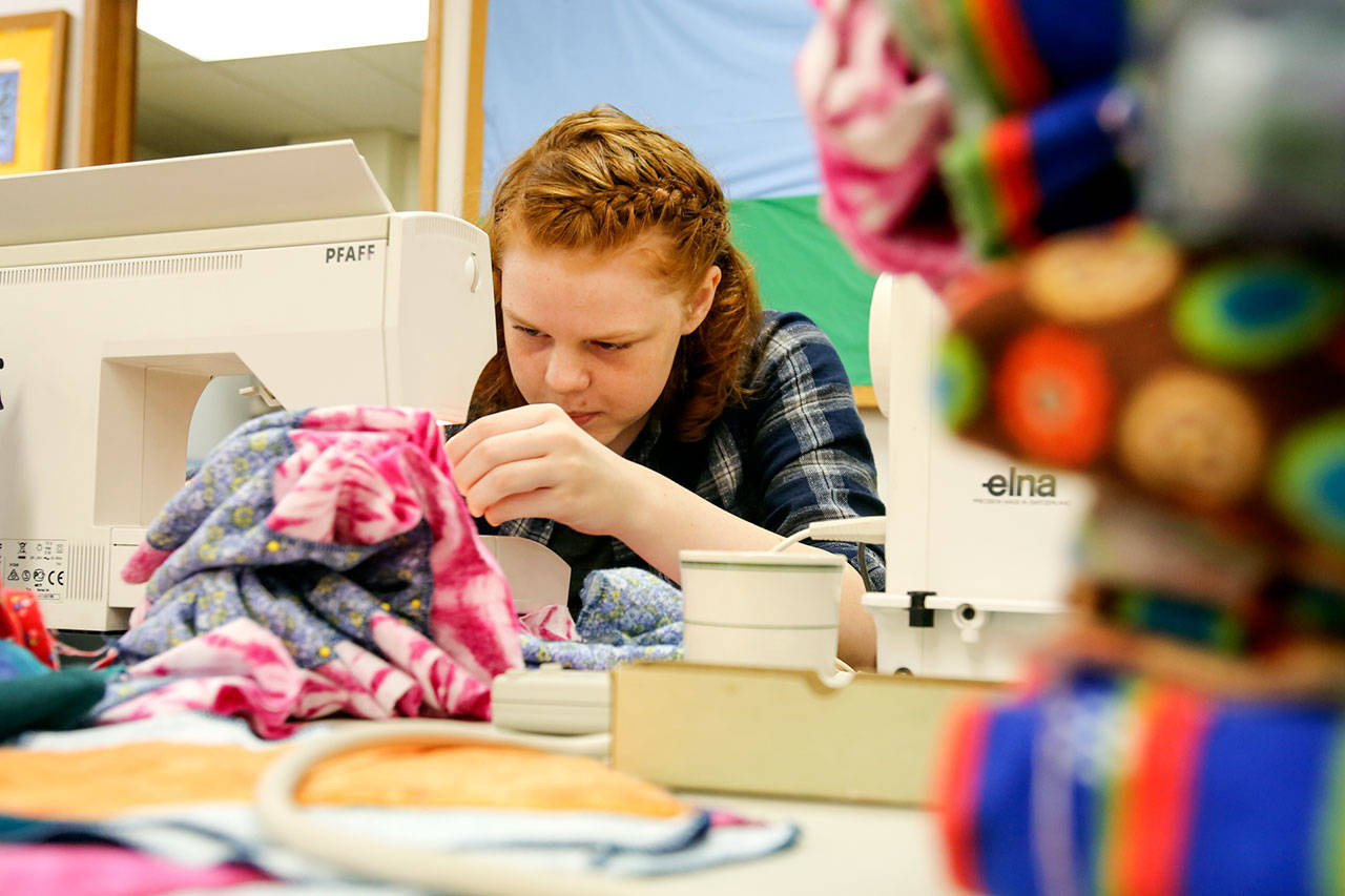 Elissa Koozer sews components of liners for hygiene kits women around the world for Saturday morning at Bethel Baptist Church in Everett on June 17, 2017. (Kevin Clark / The Herald)