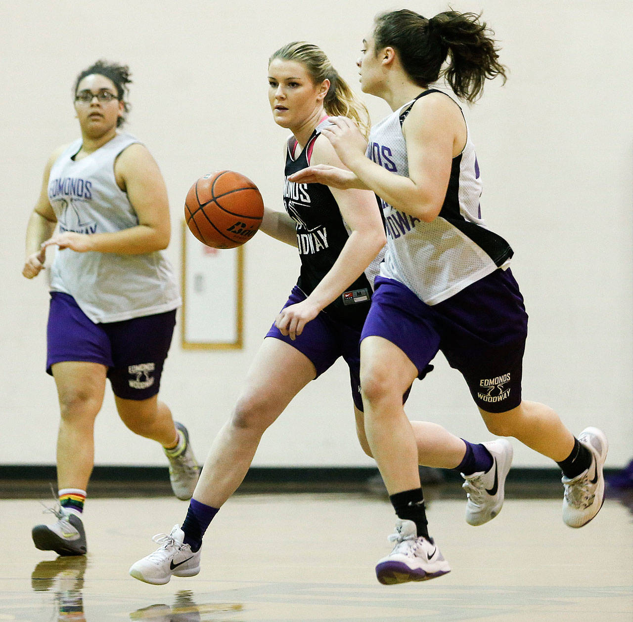 Seen here during a Feb. 2016 practice, Edmonds-Woodway’s Missy Peterson (center) takes the ball up court during a team practice at the school. Originally signed to play for Long Beach State, she was allowed out of her commitment to follow the school’s former coach to the University of Washington. (Ian Terry / The Herald)