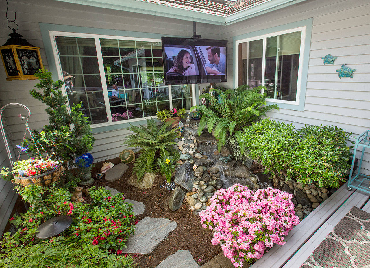 Bill and Carol Arkell installed a TV outdoors at their home. (Andy Bronson / The Herald)