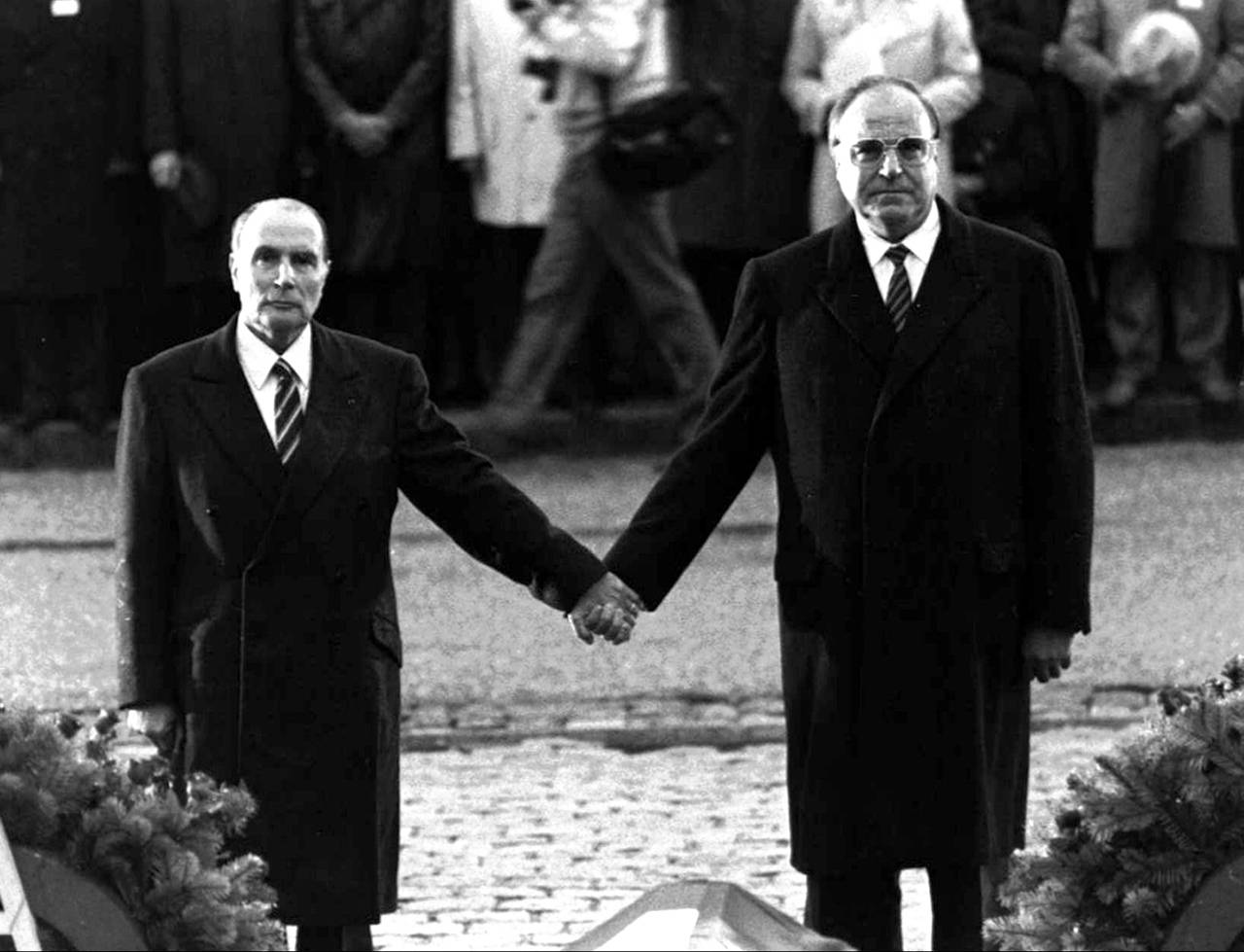 This Sept. 22, 1984 photo shows then French President Francois Mitterrand and German Chancellor Helmut Kohl standing hand-in-hand as they listen to their respective national anthems during a French-German reconciliation ceremony outside the Doaumont cemetery near Verdun. Verdun was the bloodiest battlefield in World War I. (AP Photo, file)