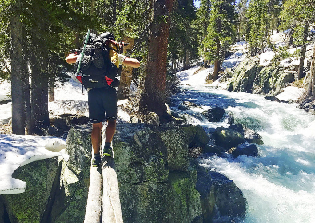 In this June 16 photo, Jake Gustafson crosses Bear Creek along the Pacific Crest Trail near Kings Canyon National Park, California. (Wesley Tils via AP)
