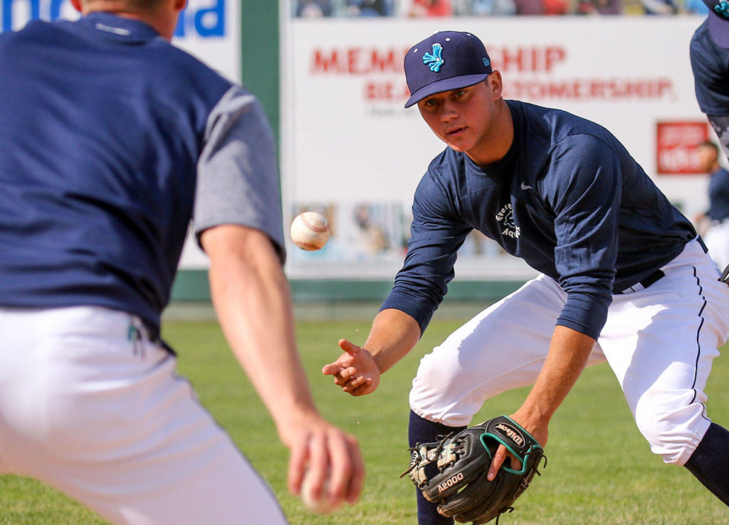 Joe Venturino, right, fields a thrown ground ball by hitting coach Austin Knight, left, during the Aquasox’s first day of training at Everett Memorial Stadium in Everett on June 11, 2017. (Kevin Clark / The Herald)
