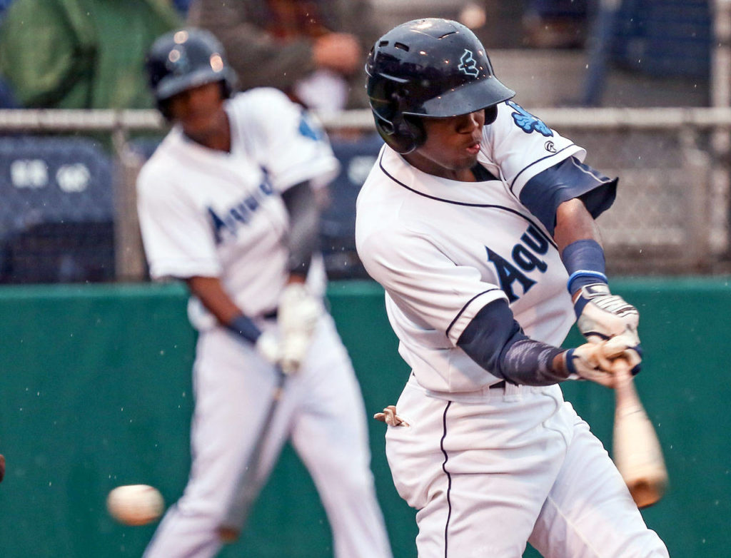 Everett’s Osby swings and misses Thursday night at Everett Memorial Stadium in Everett. (Kevin Clark / The Herald)
