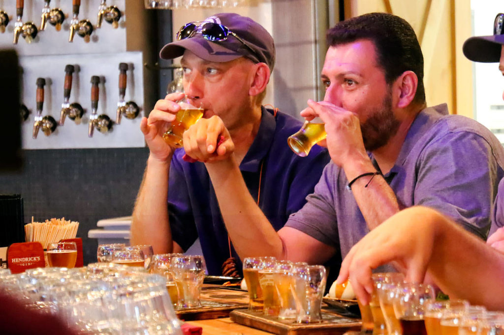 Kevin Westlund (left) and Jose Gonzalez try samples at Old Man Brewing. (Kevin Clark / The Herald)
