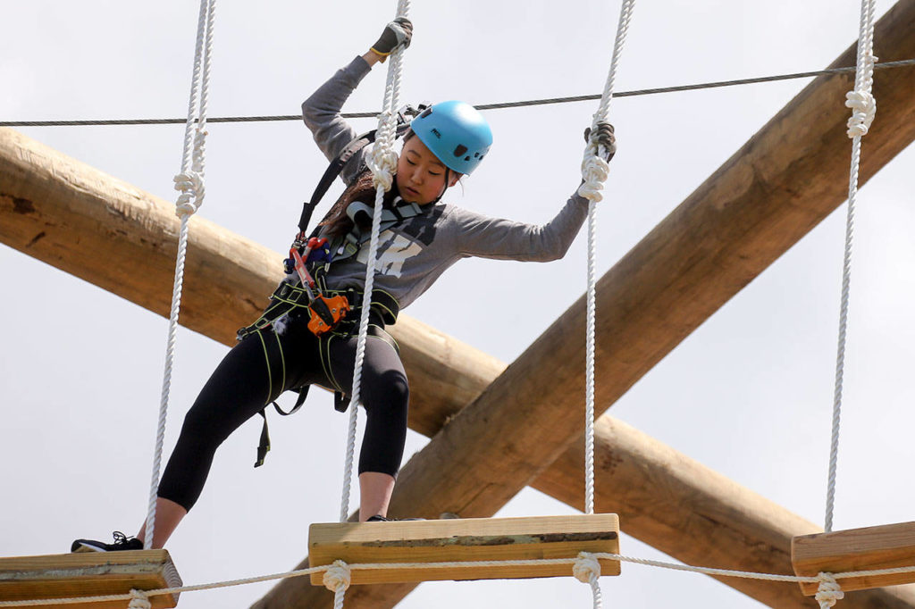 Alexis Song, 15, works the lines at High Trek Adventures at Paine Field Community Park in Everett. (Kevin Clark / The Herald)
