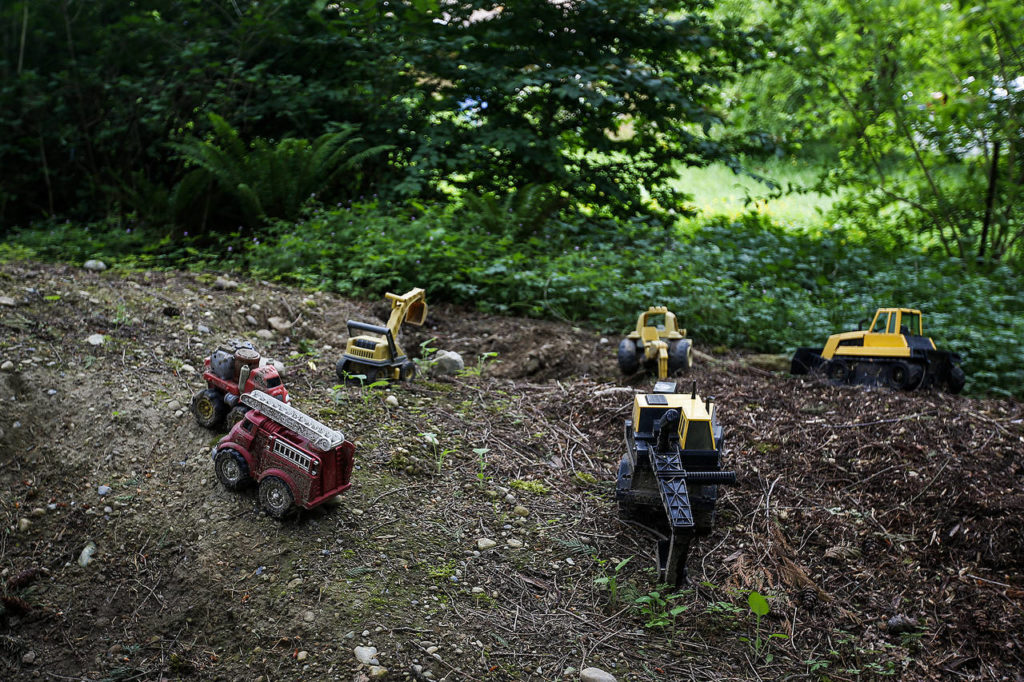 Kids toys resemble a scene from nearby housing development construction near the Songaia community in Bothell. (Ian Terry / The Herald)
