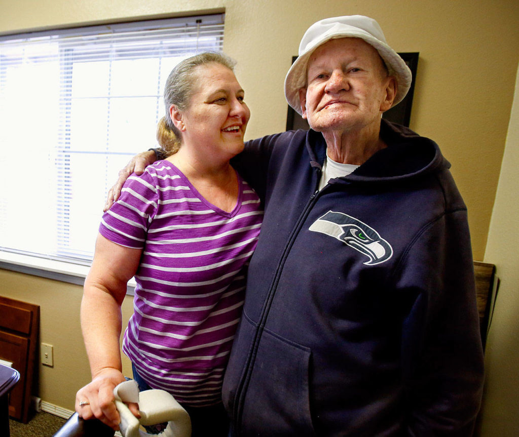 Williams gets a hug from Tammee Hindman, manager at the Woodbrook Apartments. The complex on 112th Street SE is a daily stop. Hindman has become a close friend of Williams. (Dan Bates / The Herald)
