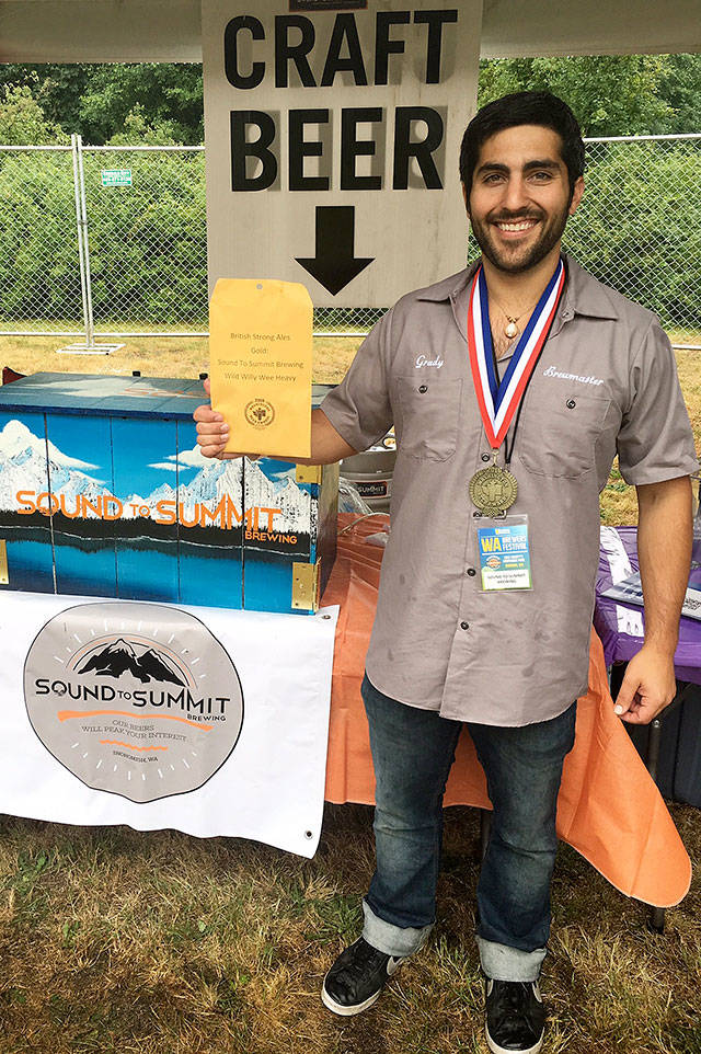 Sound to Summit brew master Grady Warnock wears the gold medal the Snohomish brewery’s Wild Willy Wee Heavy won at last year’s Washington Brewers Festival. (Photo courtesy of Sound to Summit)