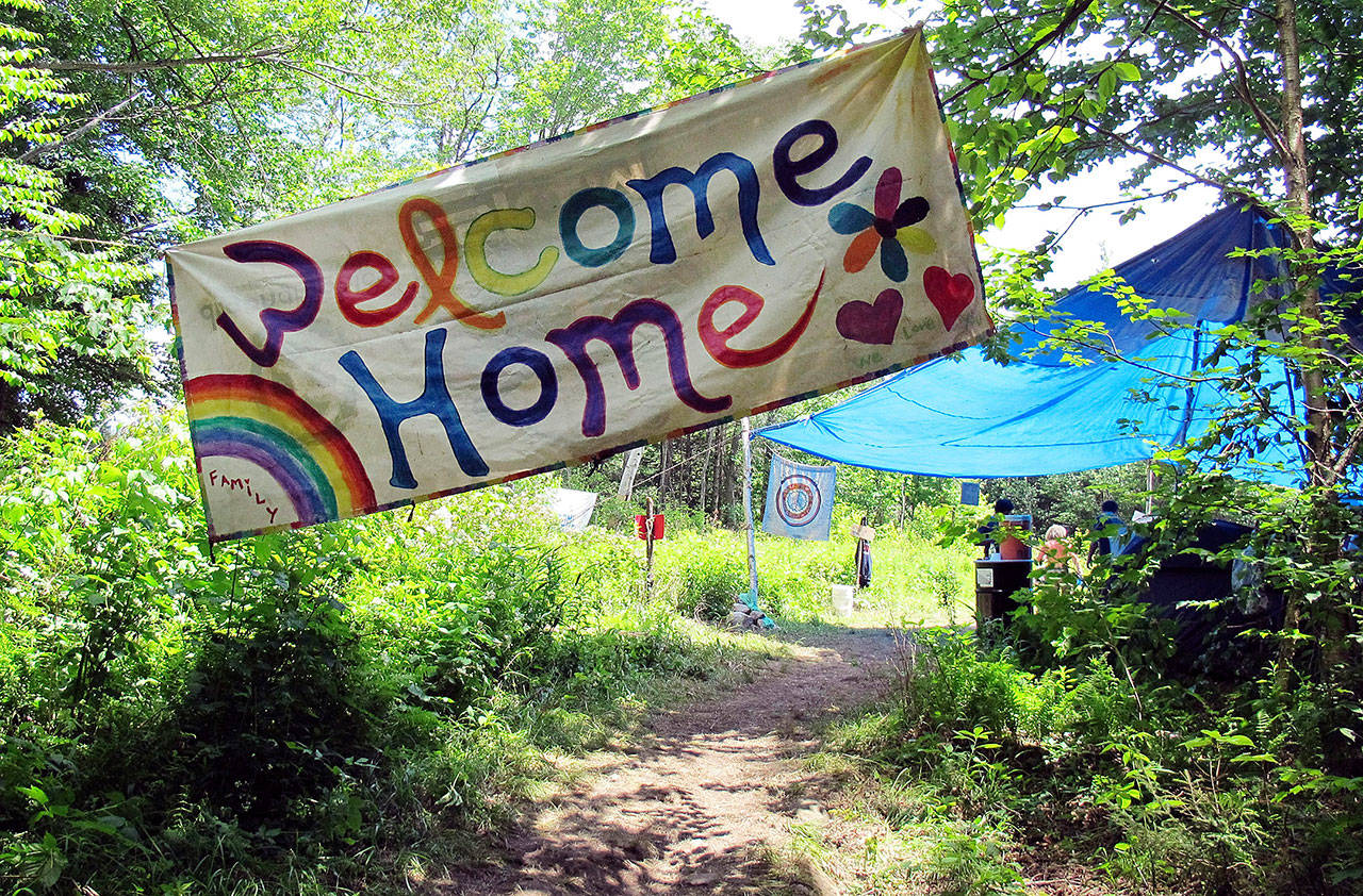 A sign welcomes people to the gathering of the Rainbow Family of Living Light in Mount Tabor, Vermont, on June 28, 2016. (AP Photo/Wilson Ring, file)