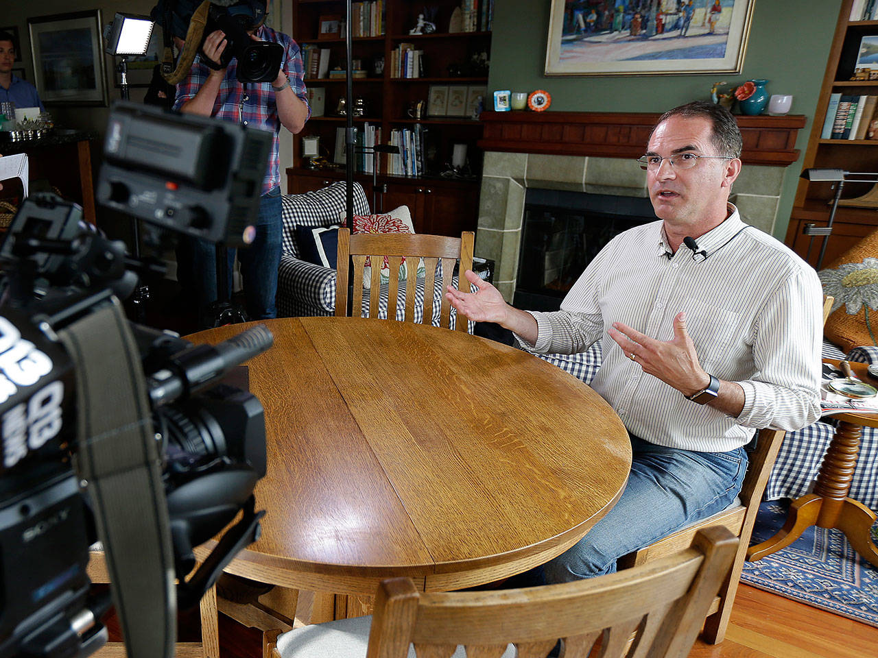 Mark Elster talks to reporters during a news conference in his home Wednesday in Seattle. Elster is a plaintiff in a new lawsuit challenging Seattle’s first-in-the-nation voucher system for publicly financing political campaigns. (AP Photo / Ted S. Warren)