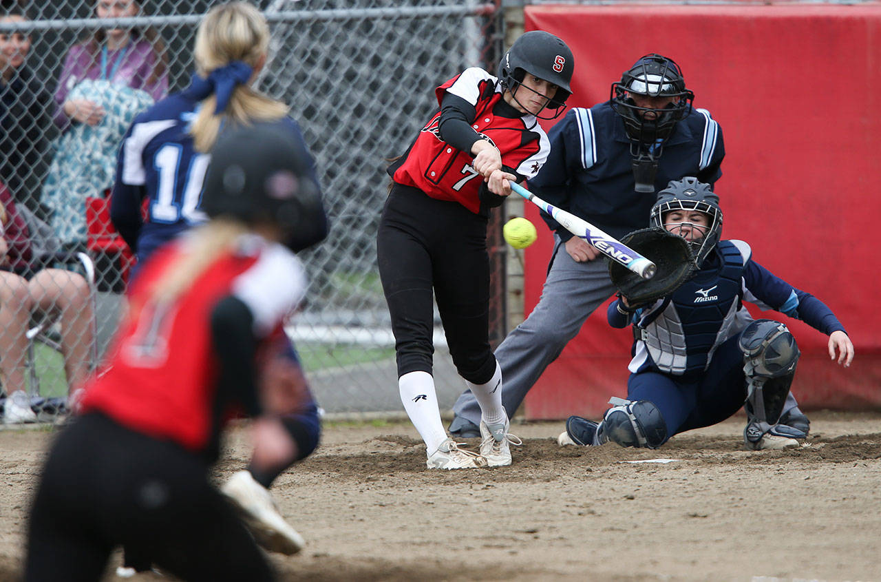 Snohomish’s Bailey Greenlee (batting), and Meadowdale’s Emma Helm (catching) and Lauren Dent (pitching) were first-team All-Wesco picks. (Andy Bronson / The Herald)