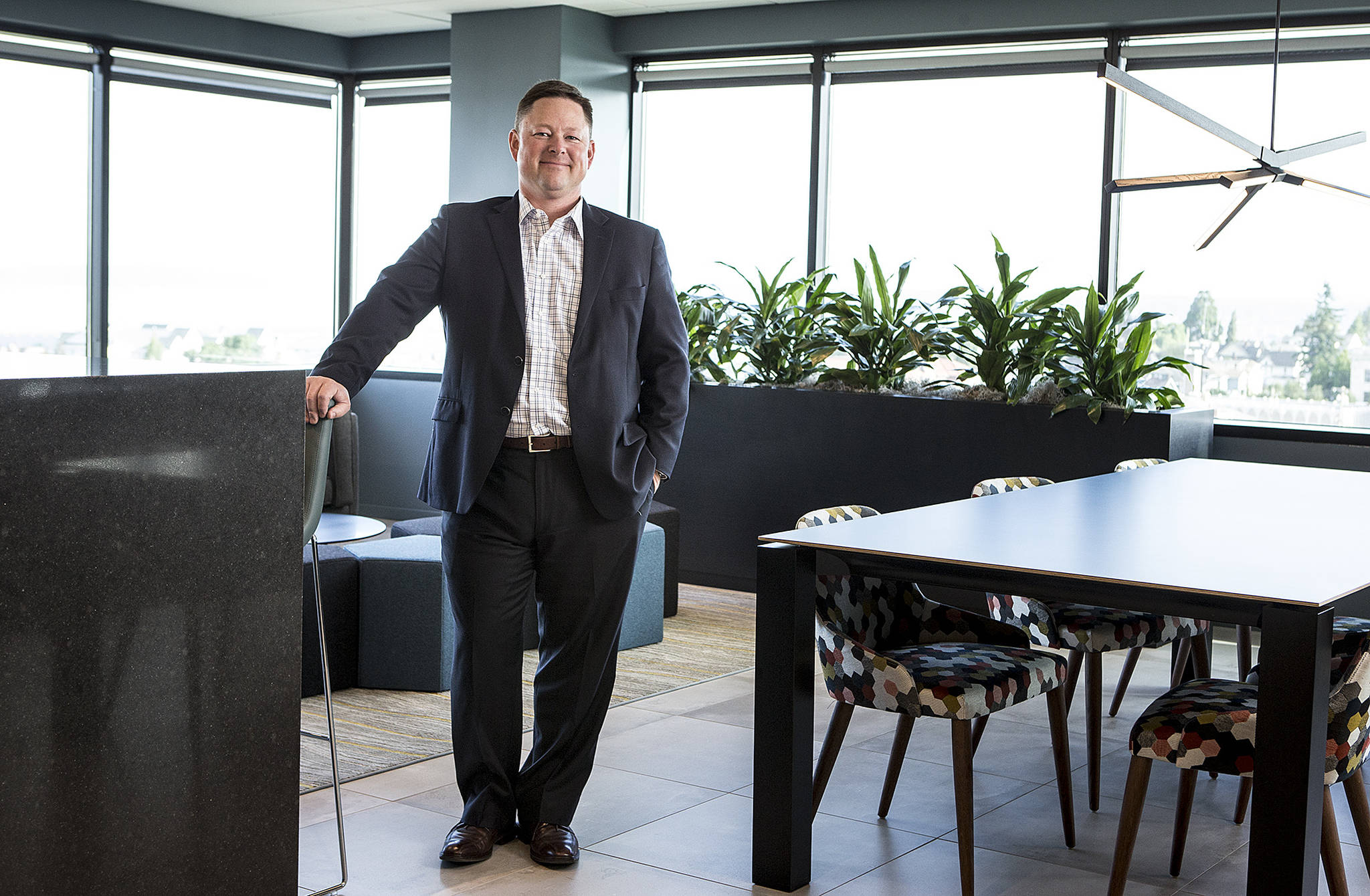 Moss Adams partner-in-charge Rob Grannum stands in a space known as ‘The Heart’ at the company’s remodeled Everett office. (Ian Terry / The Herald)