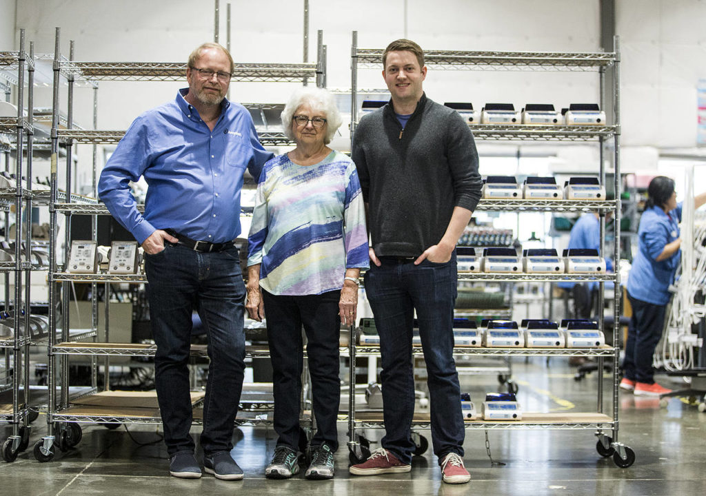 Three generations work at Aseptico including company president Glenn Kazen (left), his mother Edyie Kazen and son Stuart Kazen. (Ian Terry / The Herald)
