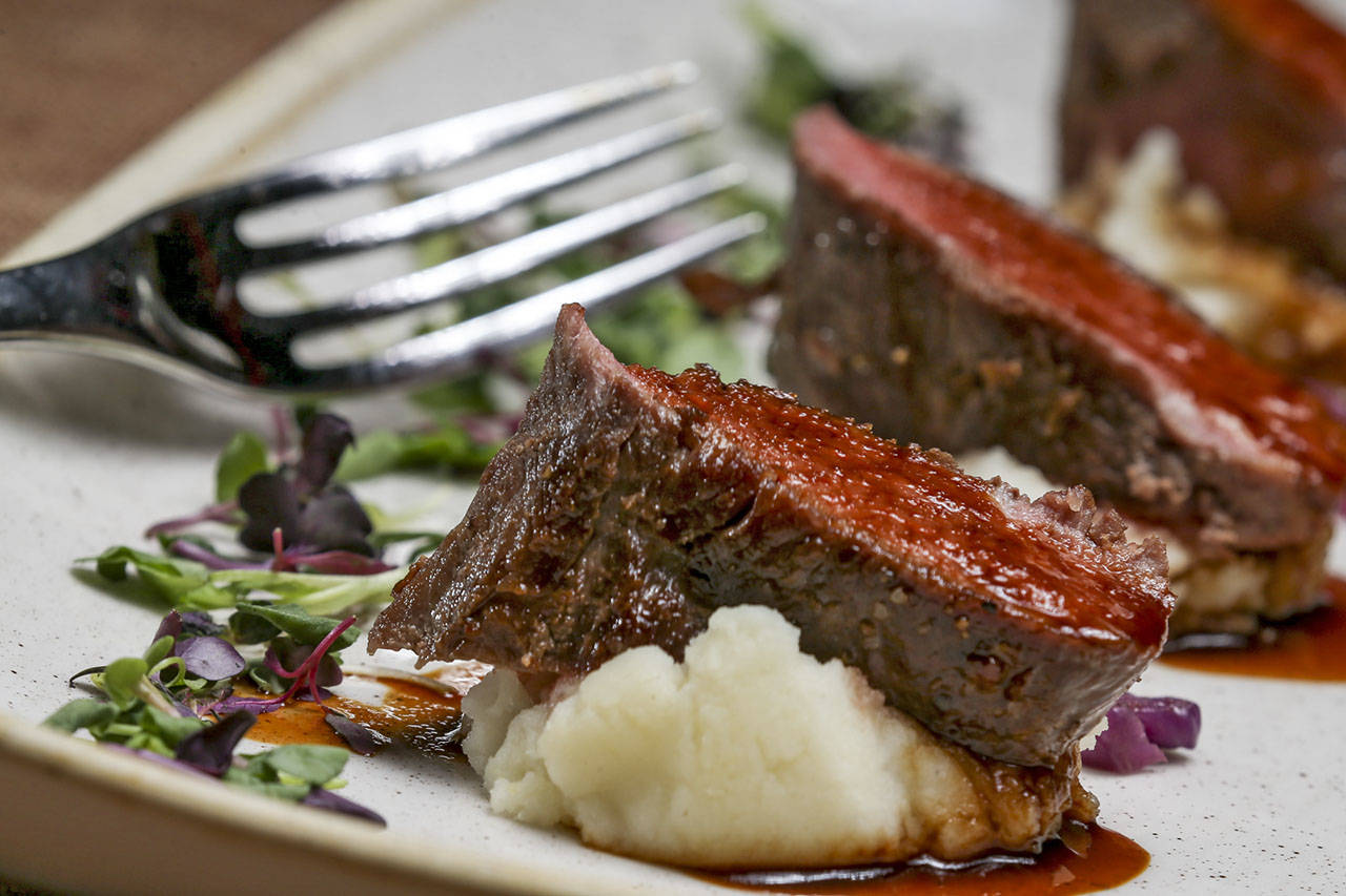 Sous Vide Venison with confit cabbage, fontina potatoes and pheasant demi-glace at Tulalip Bay Restaurant. (Kevin Clark / The Herald)