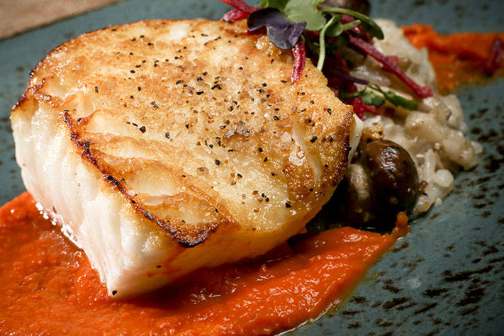 Pan Seared Sea Bass with roasted carrot puree, porcini mushroom risotto and beet chips. (Kevin Clark / The Herald)