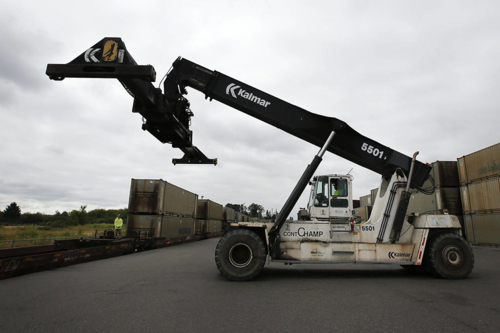 A top pick lift is seen before loading a container onto a train in Everett on Tuesday. (Ian Terry / The Herald)
