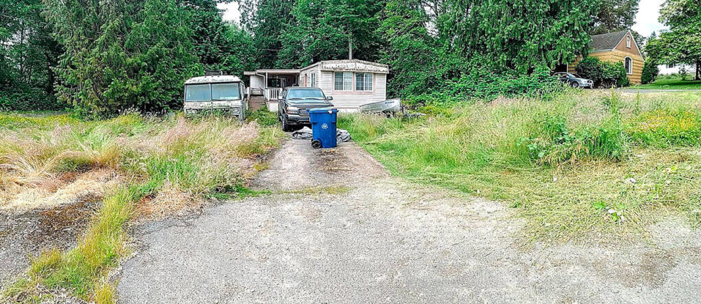 BEFORE: Resident needed help with debris, weeds and blackberry bushes . (Homage photo)
