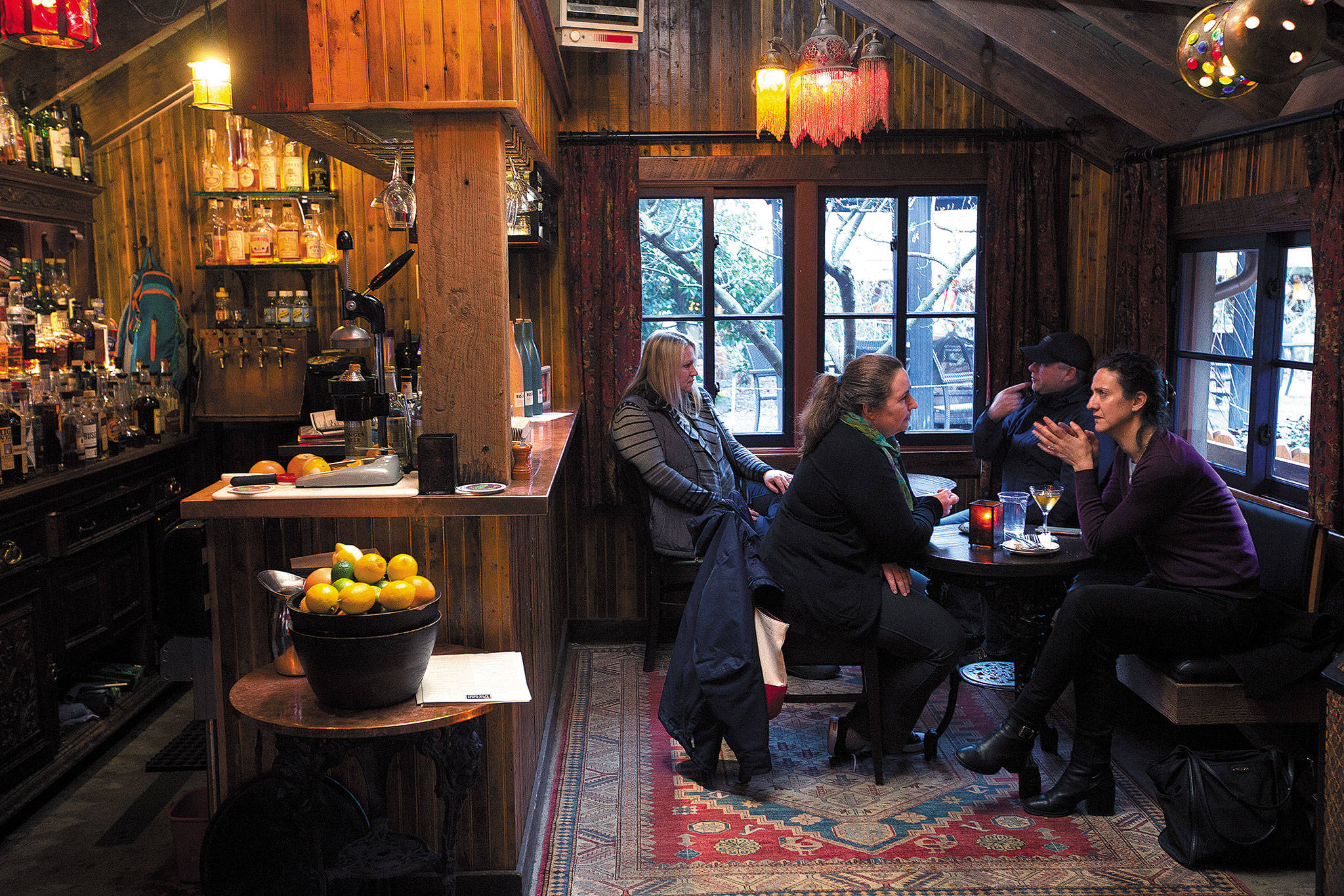 Joanne Lane (left) and Joanne Theodoulou talk in the Shed Bar at McMenamins Anderson School on March 8 in Bothell. The two are school friends from Ireland, and Lane is now a Bothell resident. (Andy Bronson / The Herald)