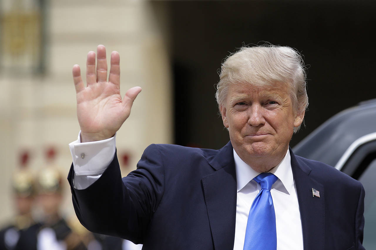 President Donald Trump waves as he arrives for a meeting with French President Emmanuel Macron at the Elysee Palace in Paris on Thursday. (AP Photo/Markus Schreiber)