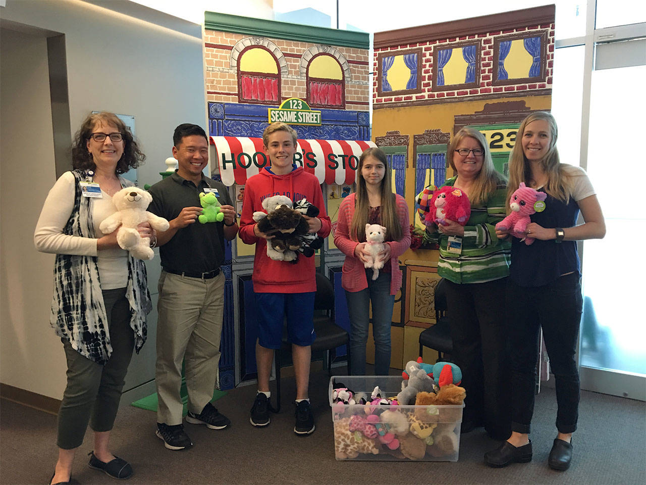 Staff members from the Children’s Center at Providence Regional Medical Center Everett accept a donation of stuffed animals from Olympic View Middle School students (center) Josh Clogston and Heike Cyphert. Not pictured is classmate Khyara Jordan. (Contributed photo)