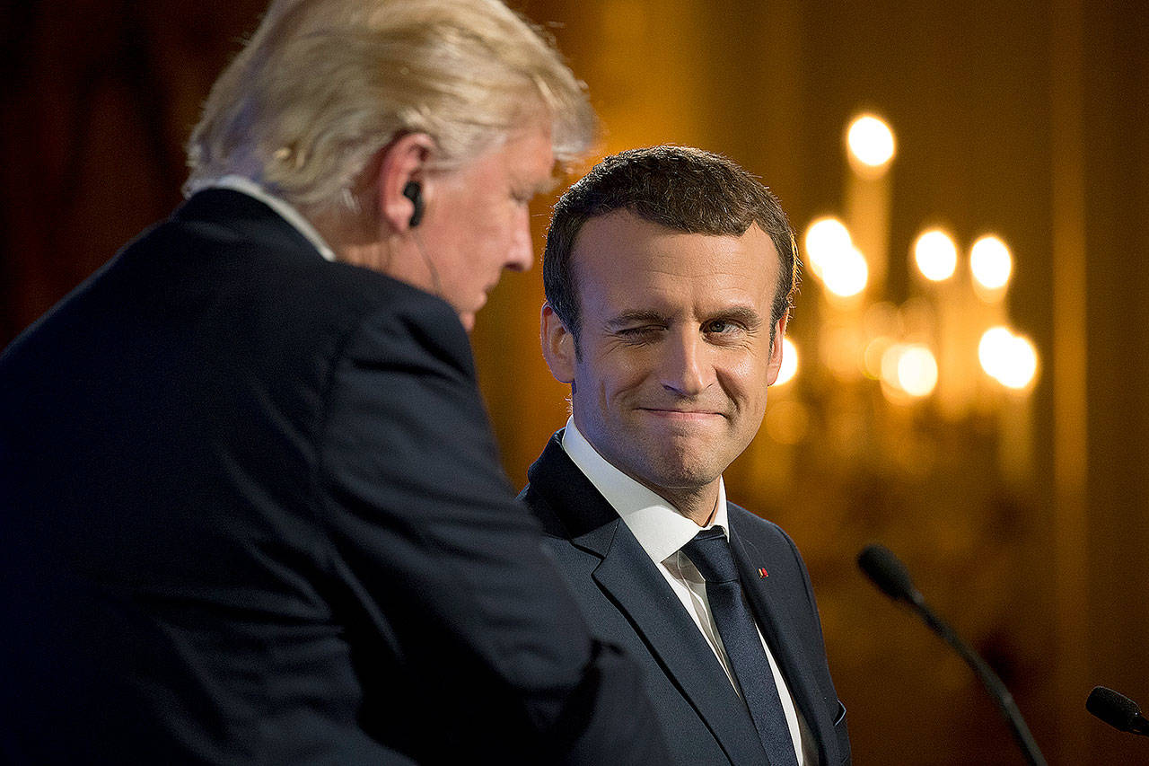French President Emmanuel Macron winks at President Donald Trump during a joint news conference at the Elysee Palace in Paris on Thursday. (AP Photo/Carolyn Kaster)