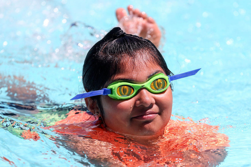 Mariah Zaragoza swims during lessons Friday afternoon at the Crystal Springs apartment complex in Everett. (Kevin Clark / The Herald)
