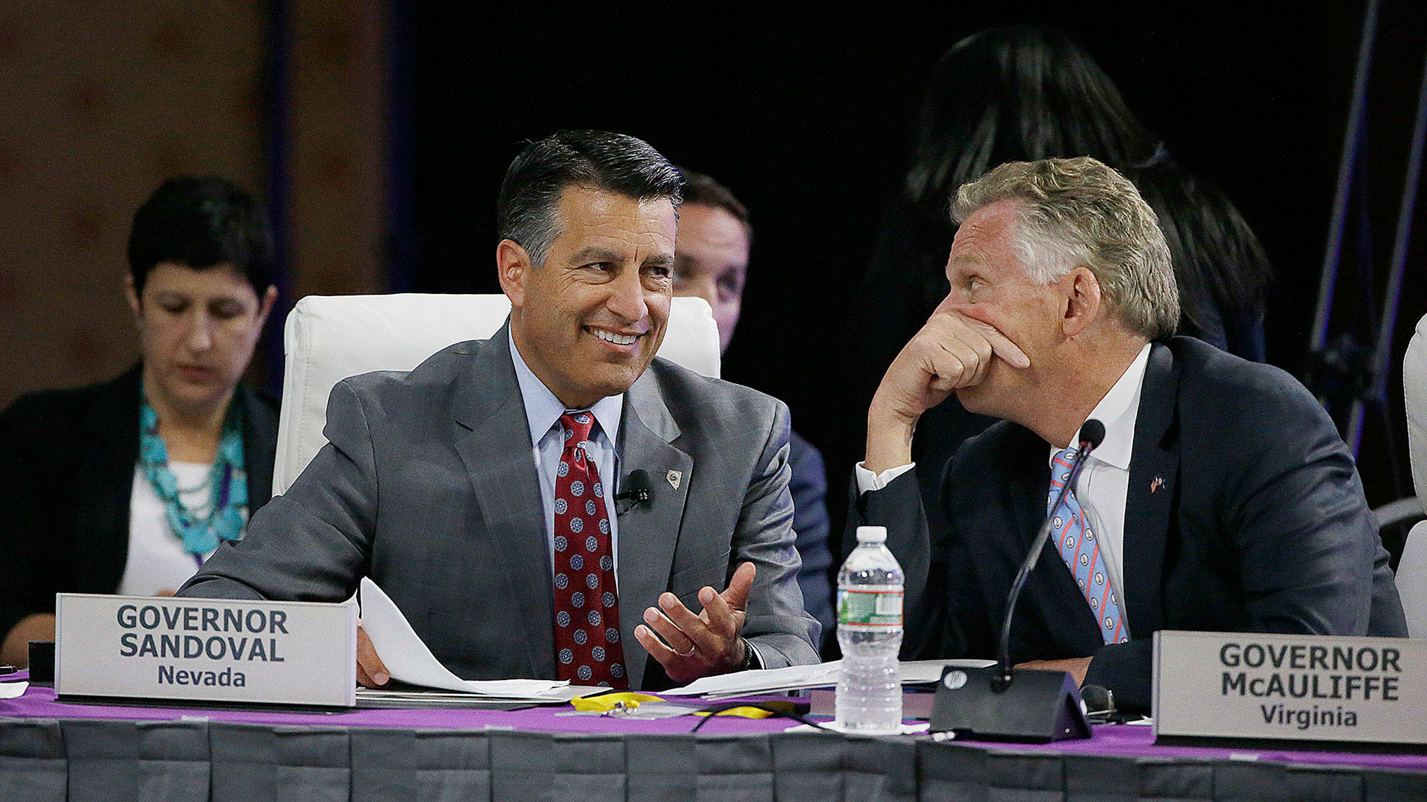 Nevada Republican Gov. Brian Sandoval (left), and Virginia Democratic Gov. Terence McAuliffe talk on the third day of the National Governors Association’s meeting Saturday in Providence, Rhode Island. (AP Photo/Stephan Savoia)