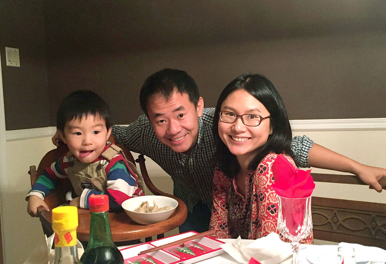 In this undated photo, Xiyue Wang, a Chinese-American Princeton graduate student, poses for a photo with his wife, Hua Qu, and their son in an unknown location. (Family of Xiyue Wang / Princeton University via AP)