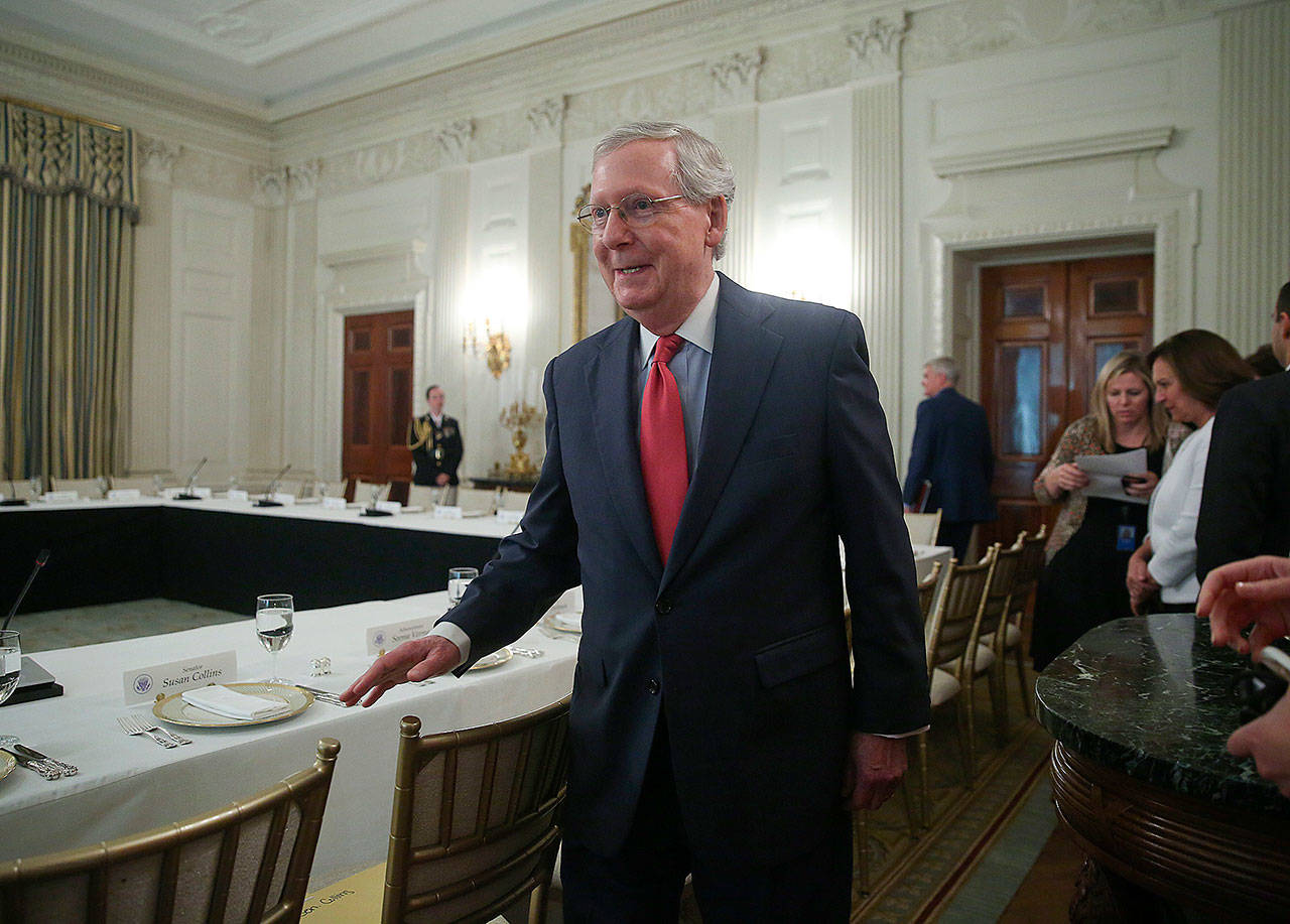 Senate Majority Leader Mitch McConnell walks to his seat for a luncheon between GOP leadership and President Donald Trump on Wednesday in the State Dinning Room of the White House. (AP Photo/Pablo Martinez Monsivais)