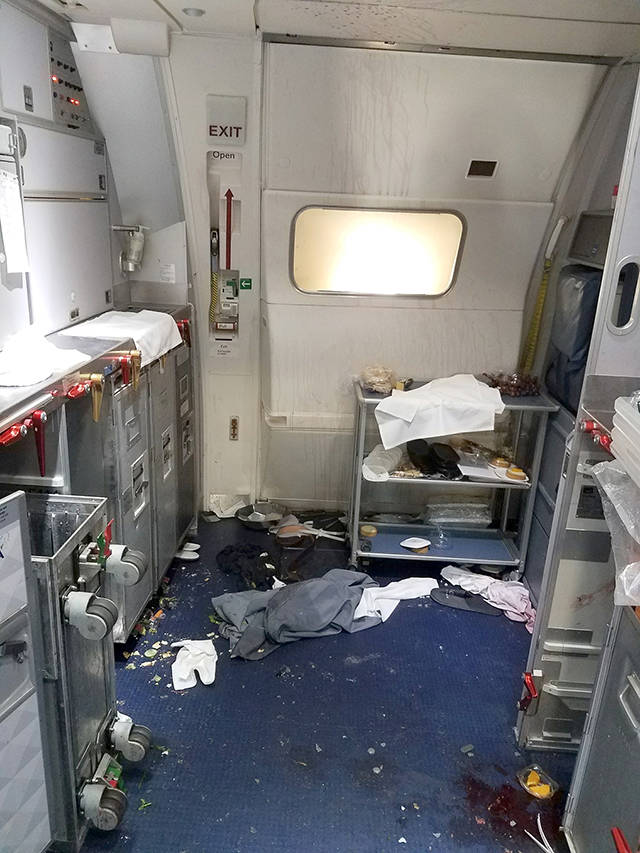 This July 7 photo shows the aftermath of a cabin on Delta Flight 129 from Seattle to Beijing, after authorities say flight attendants struggled with Joseph Daniel Hudek IV, a passenger who lunged for an exit door. (FBI via U.S. Attorney’s Office in Seattle via AP, File)