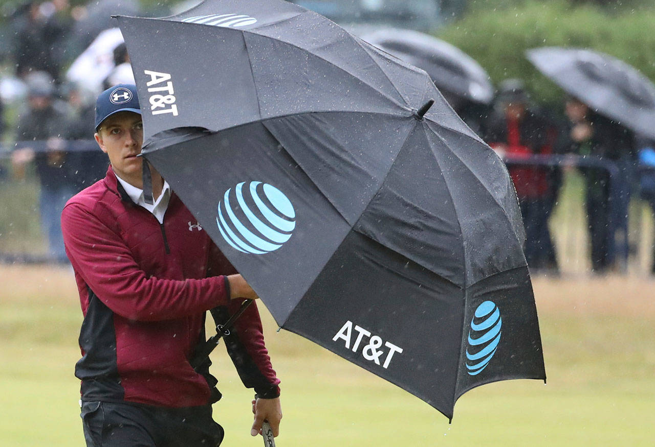 The United States’ Jordan Spieth walks along the 18th fairway and shelters from the rain during the second round of the British Open on July 21, 2017, at Royal Birkdale in Southport, England. (AP Photo/Peter Morrison)