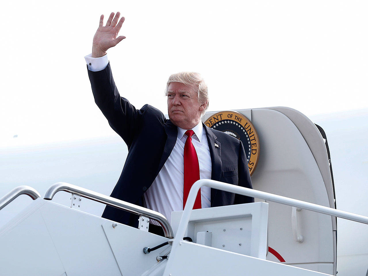 President Donald Trump waves as he boards Air Force One on Saturday at Andrews Air Force Base, Maryland. (AP Photo/Carolyn Kaster)