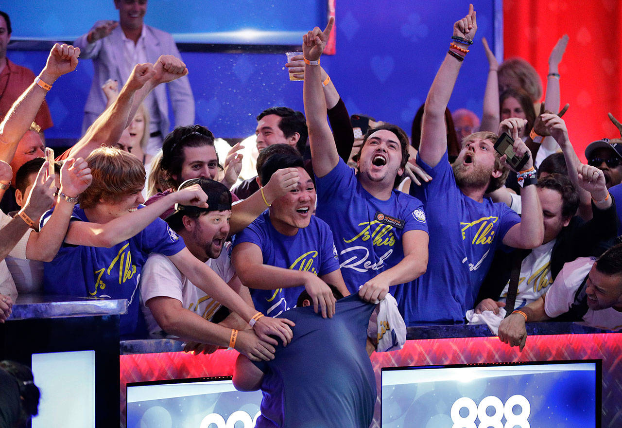 Fans celebrate after Scott Blumstein, bottom center, won the World Series of Poker main event, Sunday, July 23, 2017, in Las Vegas. (AP Photo/John Locher)