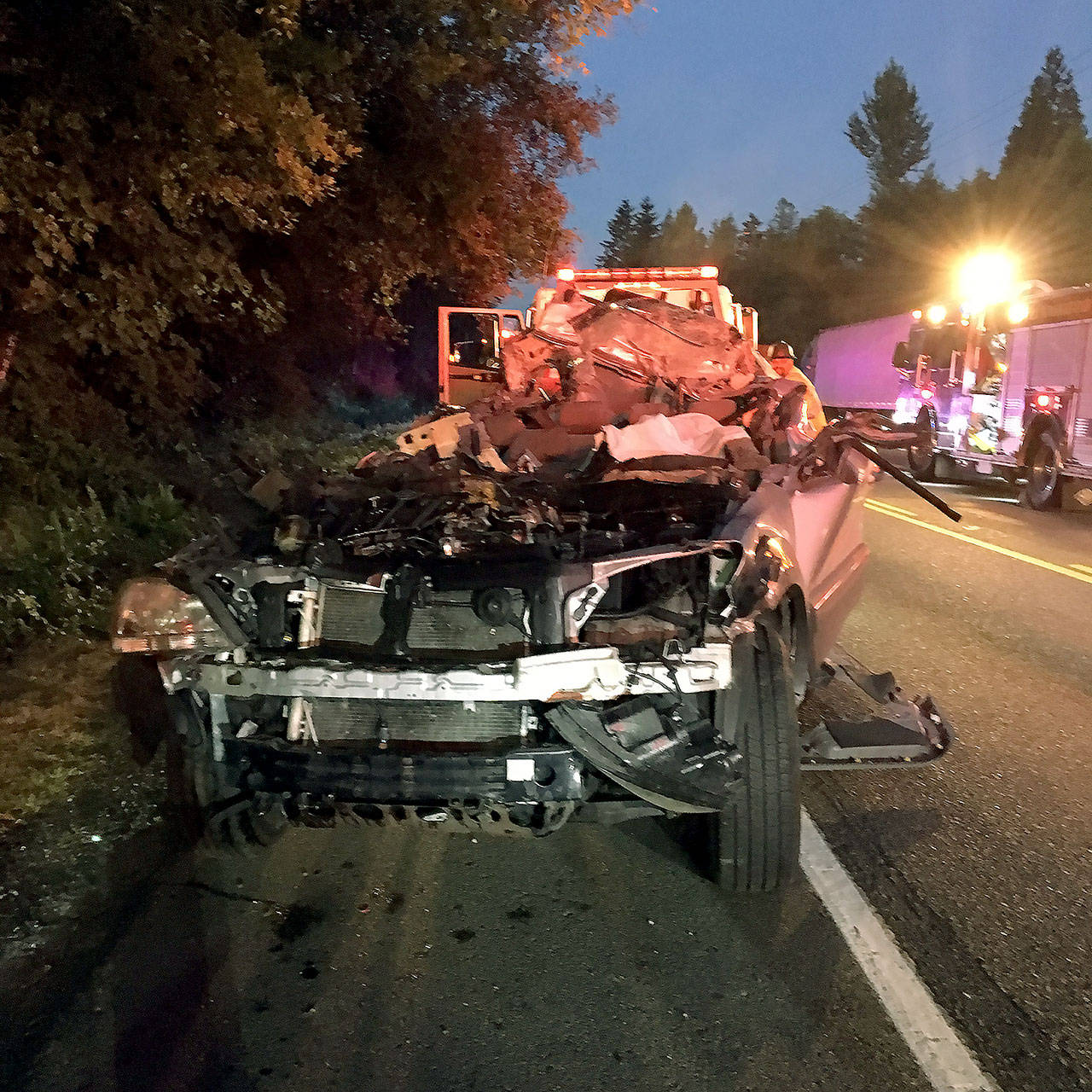 The wreckage of a vehicle that struck a parked semi trailer on Alderwood Mall Parkway early Wednesday. At least three people were killed. (Snohomish County Sheriff’s Office)