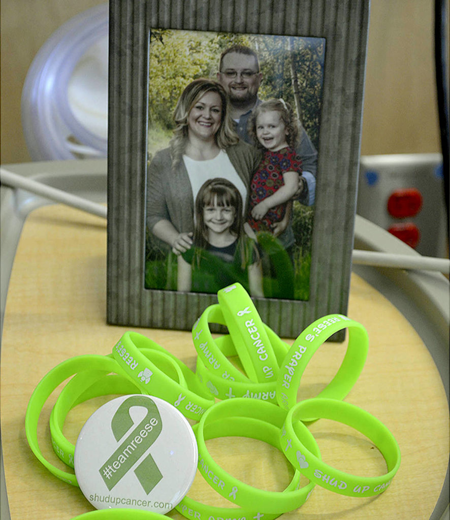 Support bracelets for Reese are lime green and have the Estes family’s motto on them: “Shud Up Cancer.” (Photo by Steven Powell / Marysville Globe)
