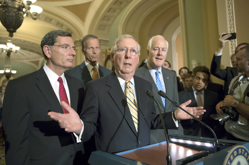 Senate Majority Leader Mitch McConnell of Kentucky, joined by (from left) Sen. John Barrasso, R-Wyo., Sen. John Thune, R-S.D., and Majority Whip John Cornyn, R-Texas, speaks with reporters on Capitol Hill in Washington on Tuesday. (AP Photo/J. Scott Applewhite)
