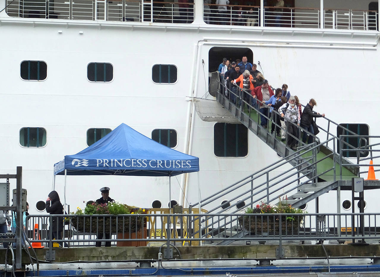 Passengers of the Emerald Princess cruise ship disembark Wednesday in Juneau, Alaska, hours after arriving at port. (AP Photo/Becky Bohrer)