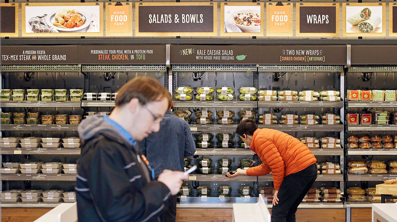 Shoppers roam through an Amazon Go store earlier this year. A new survey found that 84 percent of men are the primary grocery shoppers in their households. (AP file)