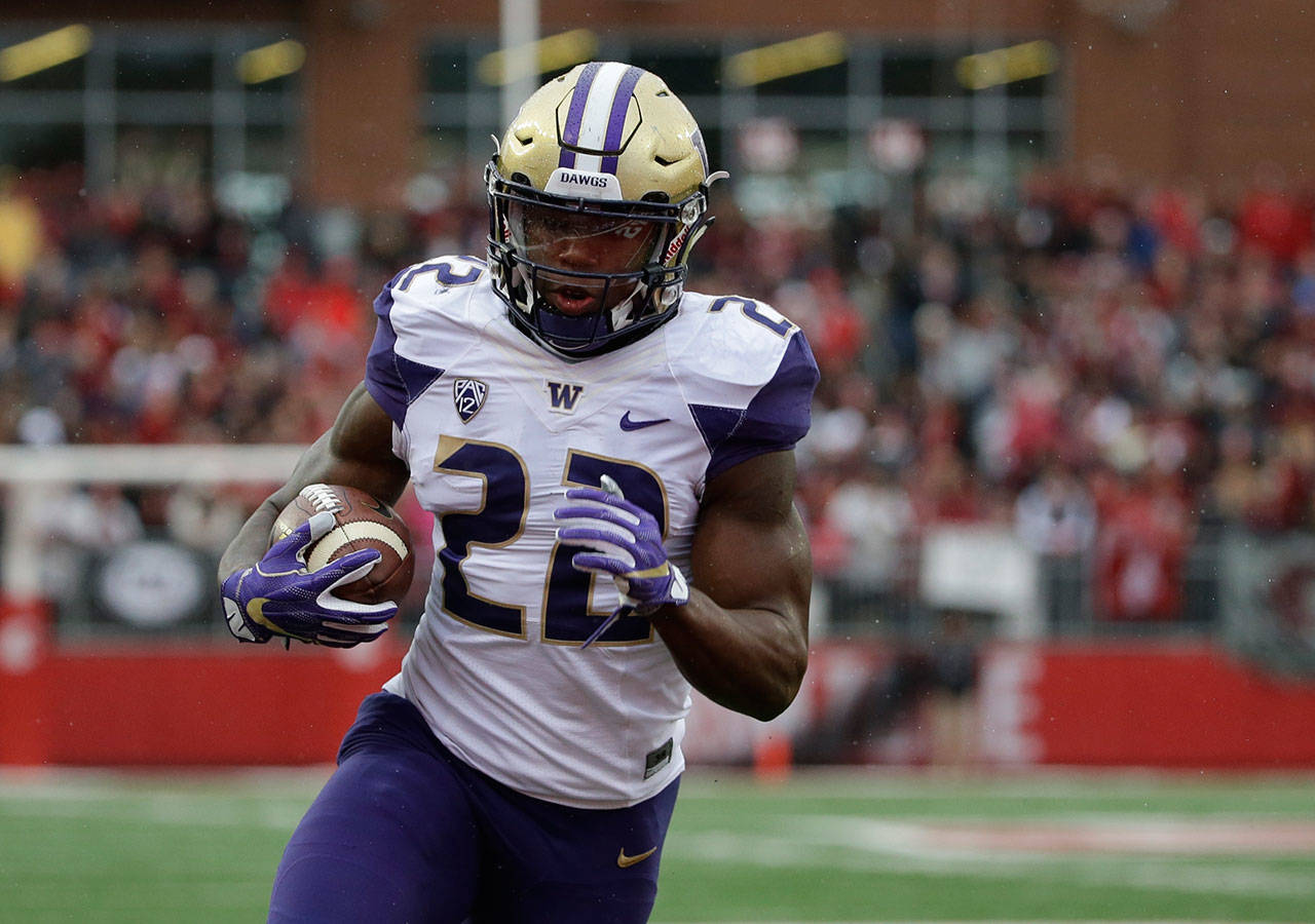 Washington running back Lavon Coleman carries the ball during a game against Washington State on Nov. 25, 2016, in Pullman. (AP Photo/Ted S. Warren)