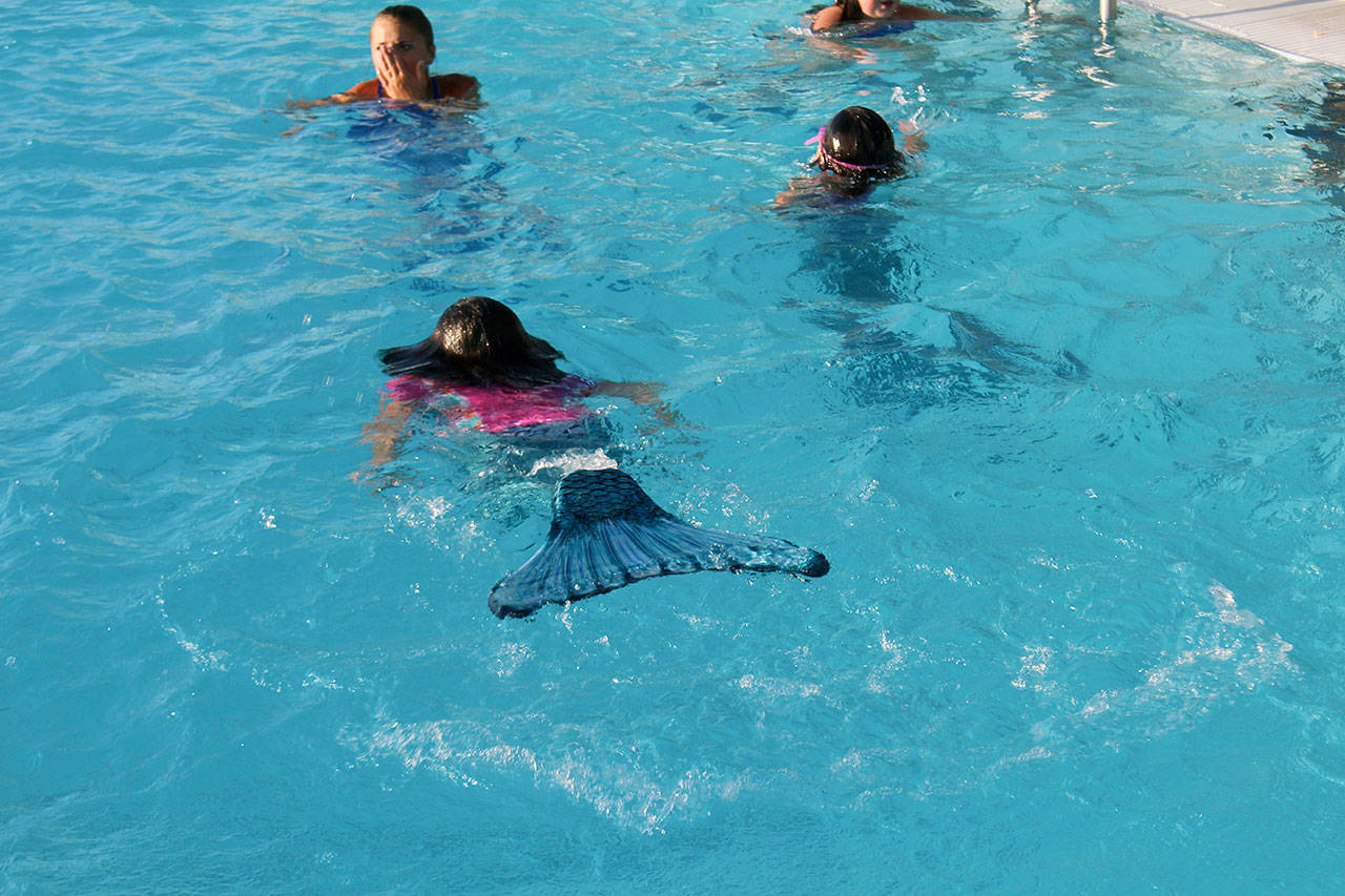 Children take a swim as mermaids at the Surf ‘n Slide Water Park in Moses Lake on July 20. Mermaid School teaches kids how to maneuver while in the water wearing a mermaid tail, but kids need to have some knowledge of swimming before they qualify for school, Lauren Ausere, who is a Surf ‘n Slide assistant manager and a Mermaid School instructor. (Cheryl Schweizer/Columbia Basin Herald via AP)