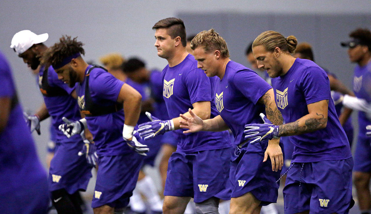 Washington defensive players run through a drill at the team’s first official practice of the year on July 31, 2017, in Seattle. (AP Photo/Elaine Thompson)