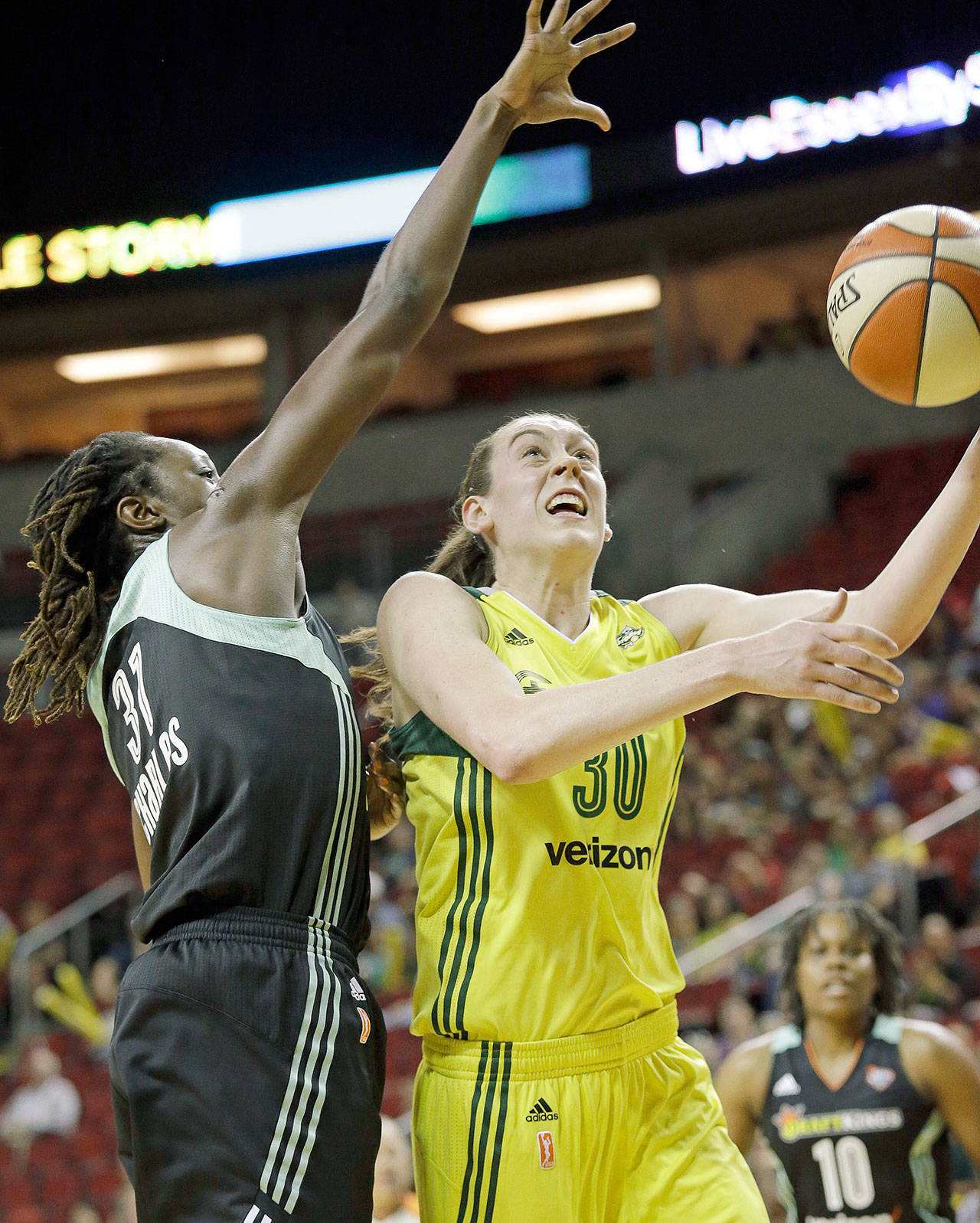 Seattle’s Breanna Stewart (right) drives past New York’s Tina Charles during the Storm’s 79-70 loss to the Liberty on Thursday in Seattle. (Elaine Thompson/Associated Press)