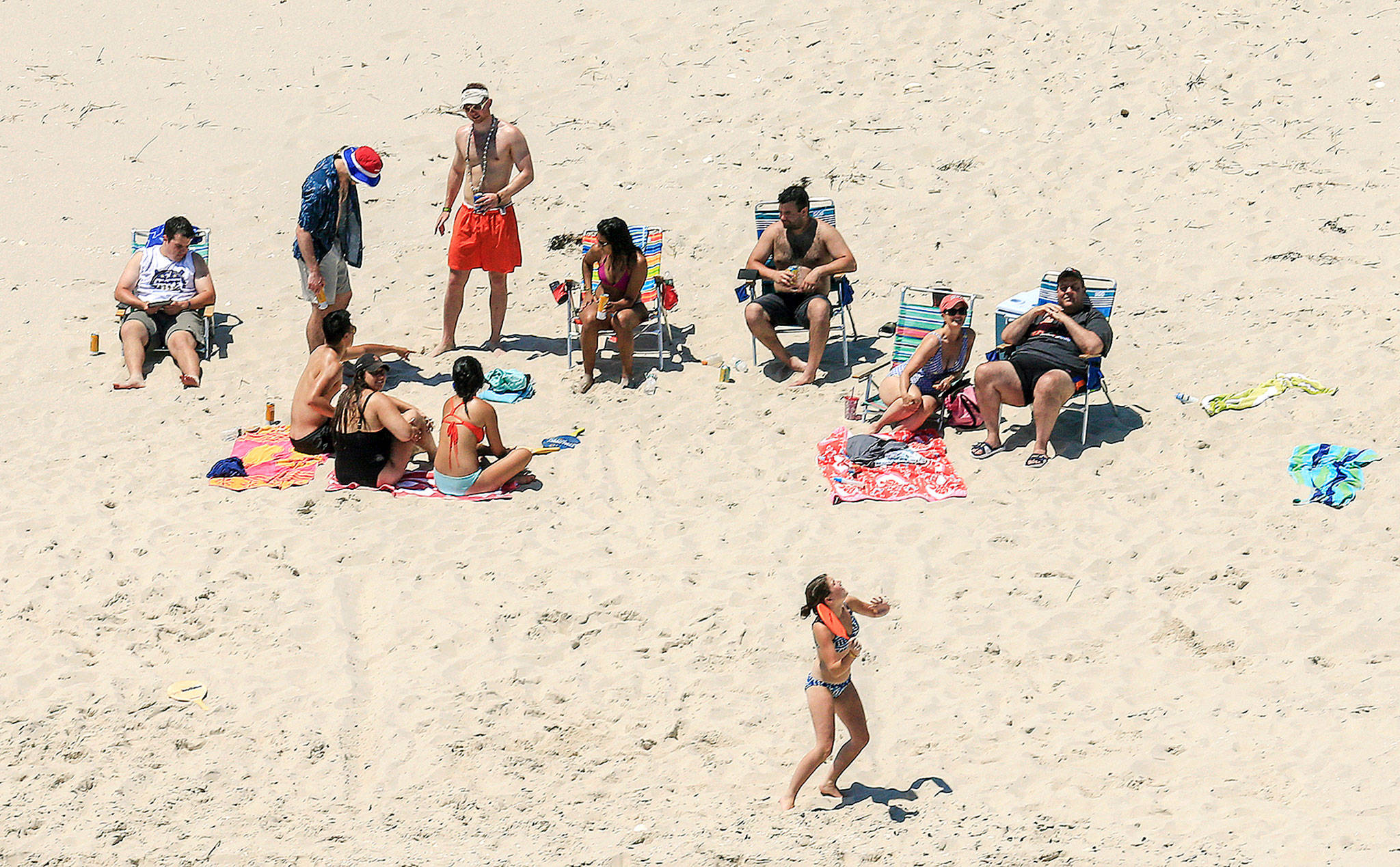 New Jersey Gov. Chris Christie (right) uses the beach with his family and friends at the governor’s summer house at Island Beach State Park in New Jersey on Sunday. Christie is defending his use of the beach, closed to the public during New Jersey’s government shutdown. (Andrew Mills/NJ Advance Media via AP)