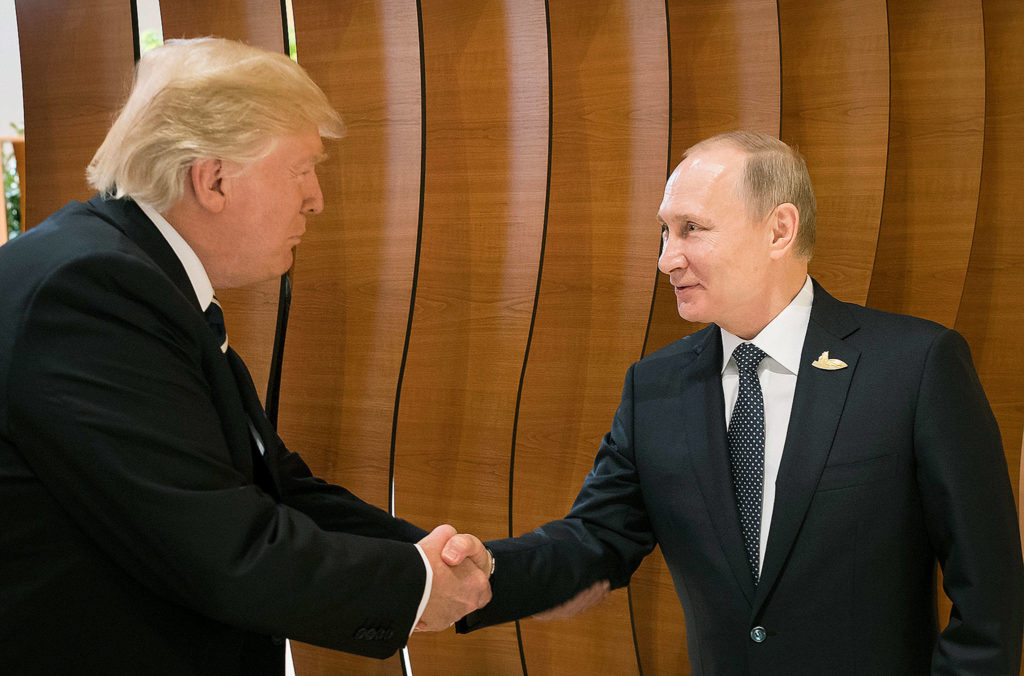 U.S. President Donald Trump (left) shakes hands with Russian President Vladimir Putin before the first working session of the G-20 summit in Hamburg, Germany. (Steffen Kugler/Presse- und Informationsamt der Bundesregierung via AP) 
