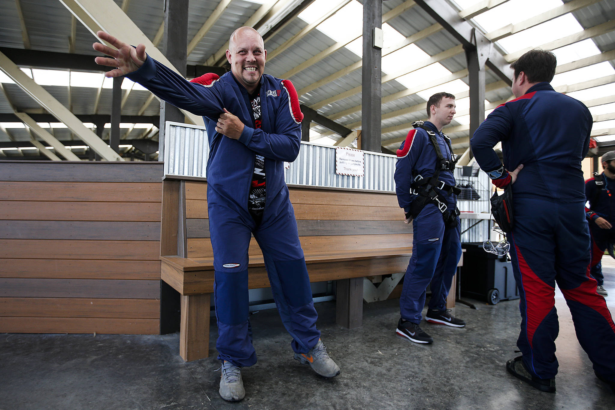 Curtis Zinn (left) suits up before skydiving at Skydive Snohomish’s Fill the Sky with Hope event on Saturday, July 1. Zinn, and others who receive assistance from Housing Hope, took to the skies on Saturday to overcome fear and celebrate their sobriety. (Ian Terry / The Herald)