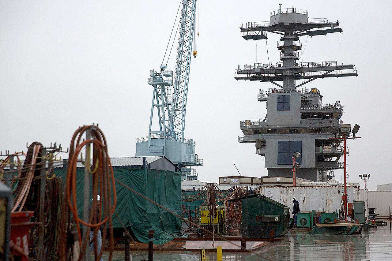 The island tower of the USS Gerald R. Ford aircraft carrier stands amid construction equipment during outfitting and testing at Huntington Ingalls Industries’ Newport News Shipbuilding shipyard in Newport News, Virginia, in 2014. (Andrew Harrer/Bloomberg)