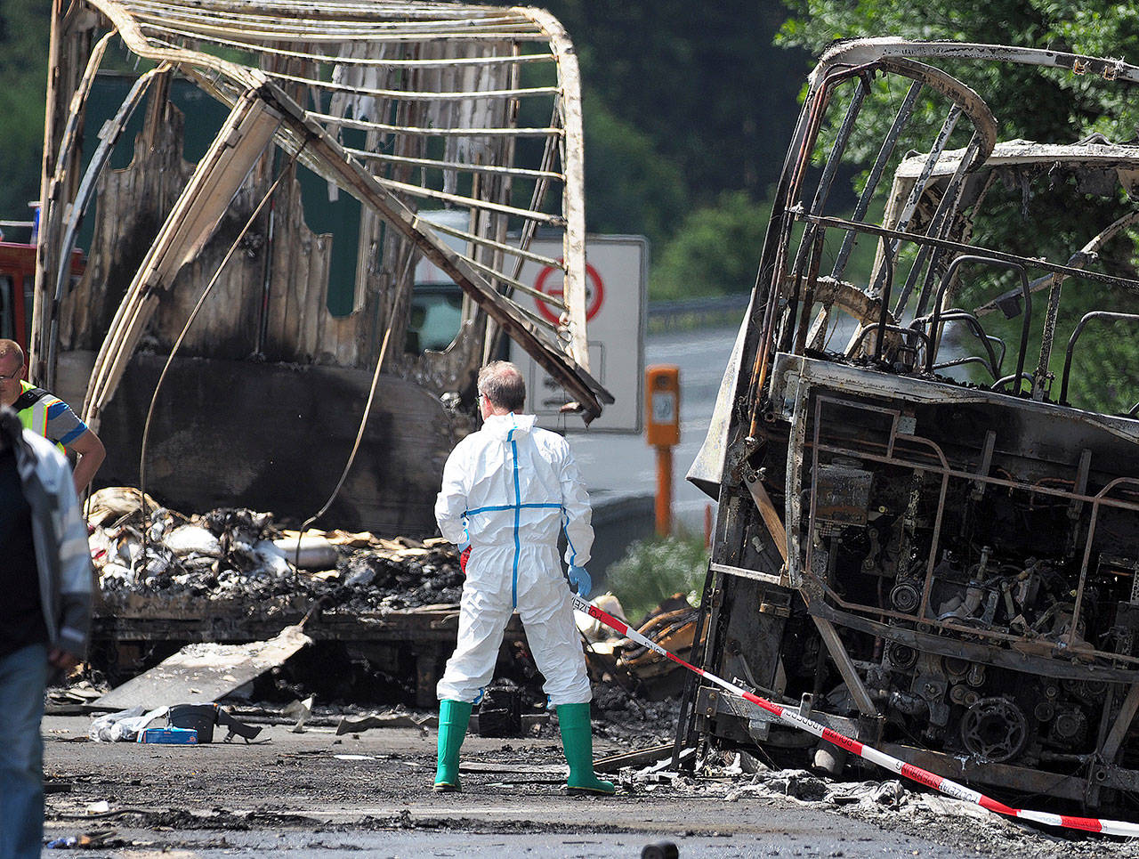 Police work at the burned-out shell of a bus near Muenchberg, Germany, on Monday. (Nicolas Armer/dpa via AP)