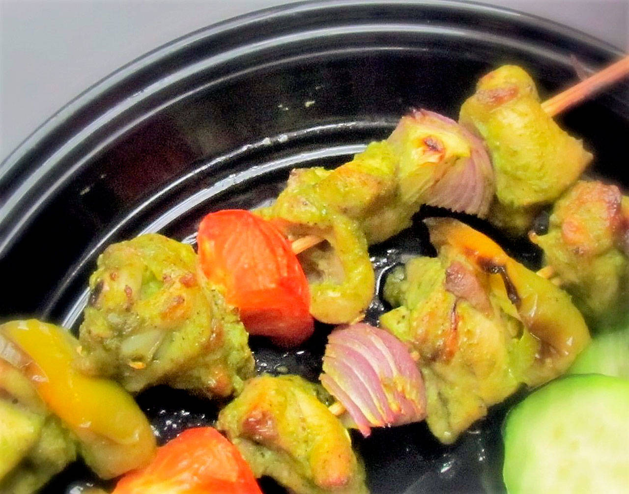 Green chicken kebabs get their color from a marinade made with cilantro and green hot Thai chilies. (Reshma Seetharam / For The Herald)