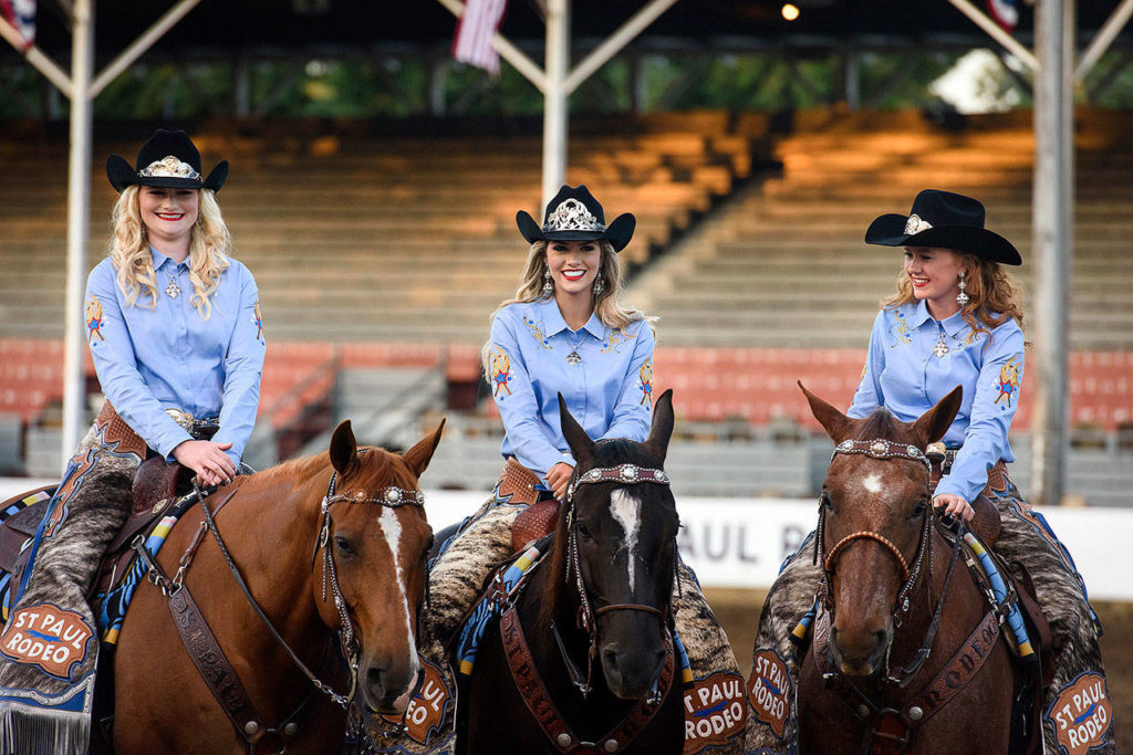 St. Paul Rodeo Princess Morgan Spear (from left), Queen Melanie Atchison and Princess Britney Norby sit on their horses, Dally, Shady and Huckleberry, as they wait for more television interviews to begin last month. Norby credits her duties as a princess on the court with giving her more confidence in public speaking. (Molly J. Smith / Statesman-Journal)

